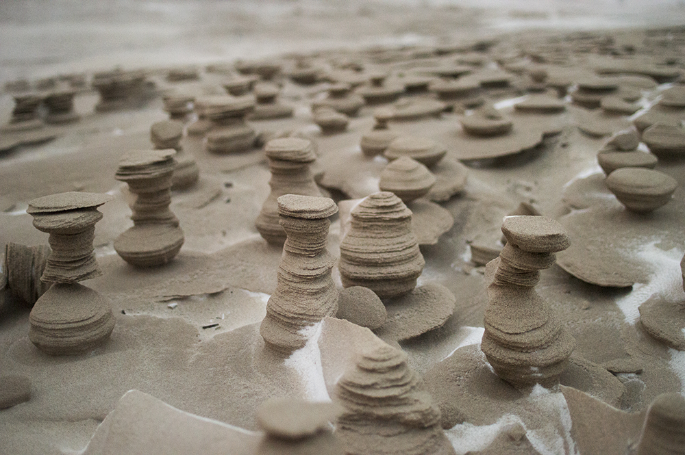 Strong Winds Carve Otherworldly Towers from Frozen Sand on the Shore of Lake Michigan